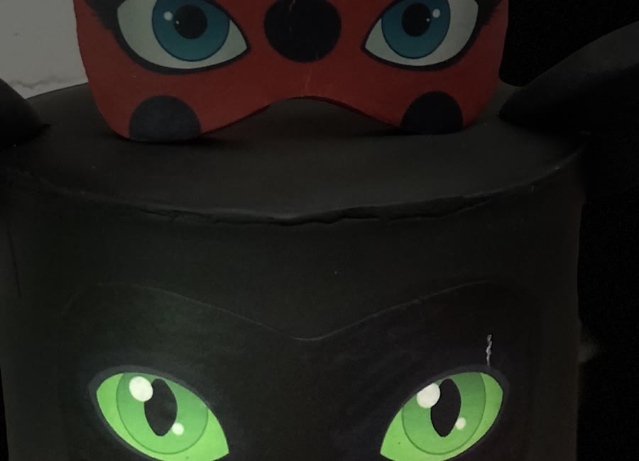 Close crop of two green eyes cut from fondant.