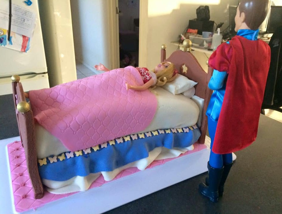 A cake modelled as a bed with a quilted cover and headboard.